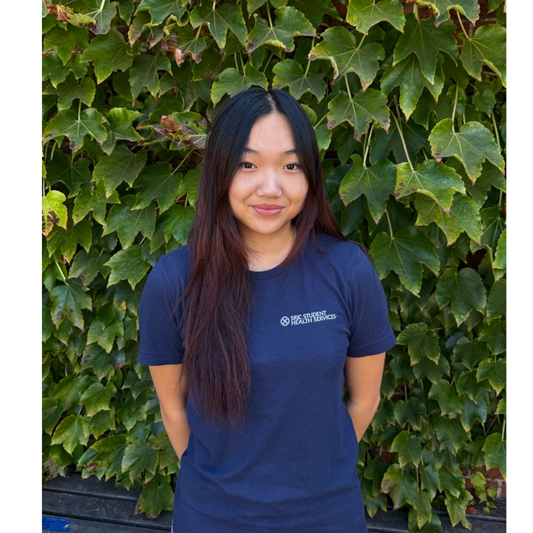 Portrait of Student Health Peer, Mina Nguyen in front of an ivy background.