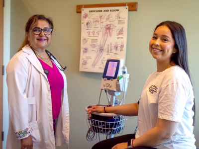 A student has her vitals checked by a nurse. 