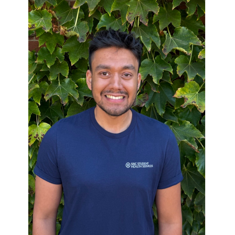 Portrait of Student Health Peer, Sahil Prasad in front of an ivy background. 
